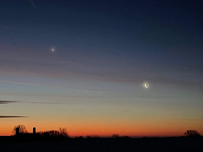 Bright "star" (really a planet) and the crescent moon, as dawn breaks.