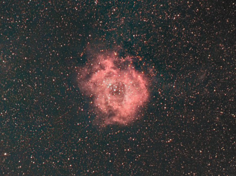 Reddish puffy, donut-shaped cloud on a black starfield.