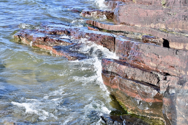 Rocky shoreline with splashing waves.