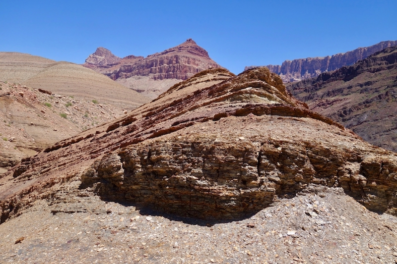 Earth's oxygen: Layered rocky outcrop with blue sky above.