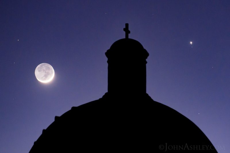 Moon and Jupiter photos: Moon on left, Jupiter on right, mission-like building in between, in a twilight sky.