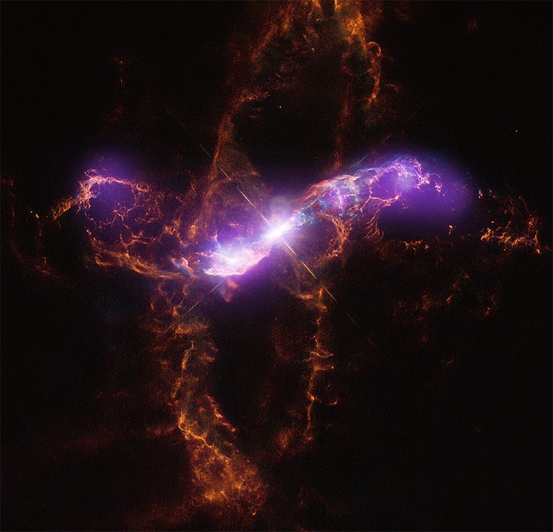 Wispy reddish rings oriented at right angles with fuzzy purple and white beams at center.