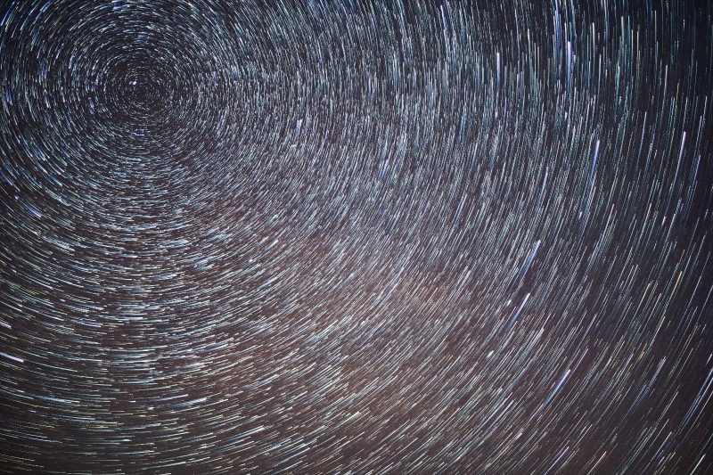 Circumpolar stars: Short white dashes in concentric circles on a black background.