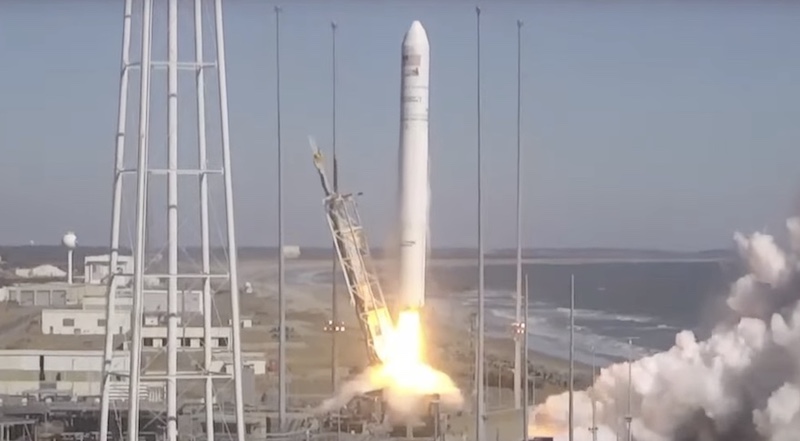 A space rocket launches near a beach.