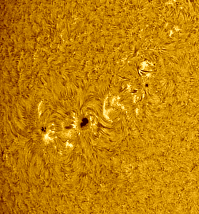 Close-up of the sun, seen as a large yellow surface with a mottled surface.