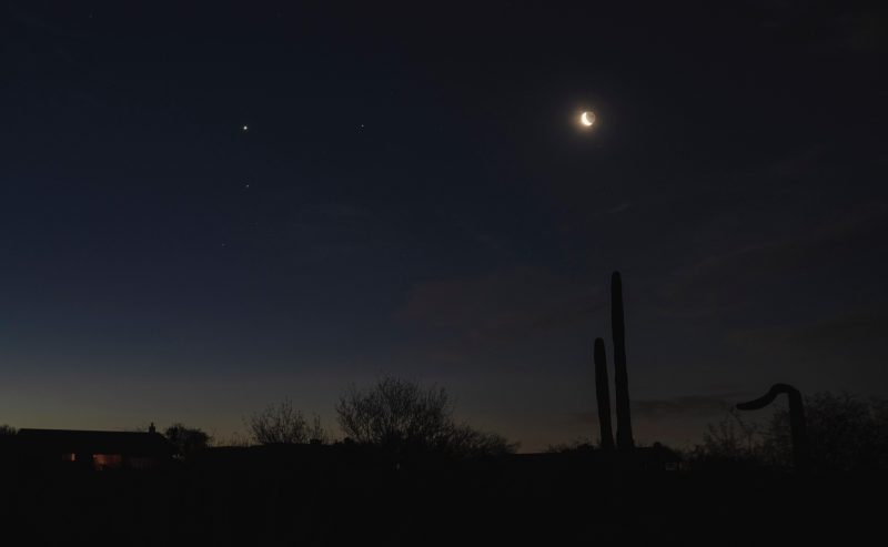 Desert panorama at dawn with three bright planets and the moon.