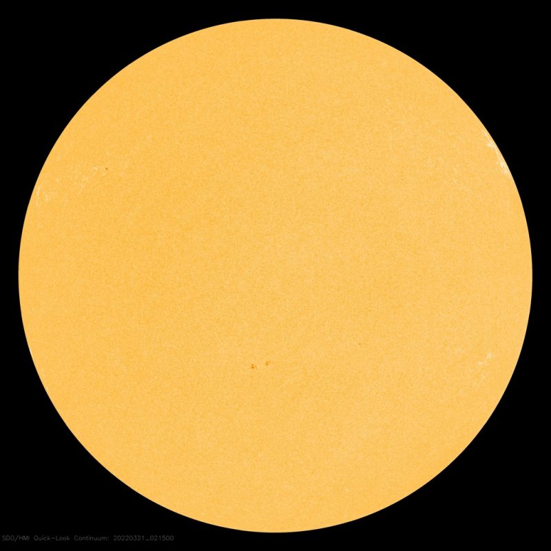 Sun activity: Large yellow sphere with small dark spots.