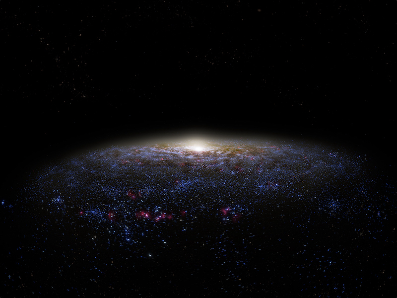 A galaxy glowing with central bright core and billions of stars in the blackness of space.