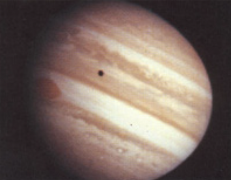 Pioneer 10's 50th anniversary: Somewhat hazy image of Jupiter, with black dot in front.