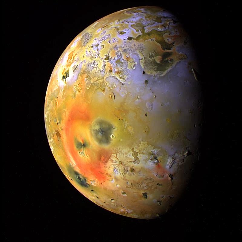 Brightly colored and mottled planet-like body on black background.