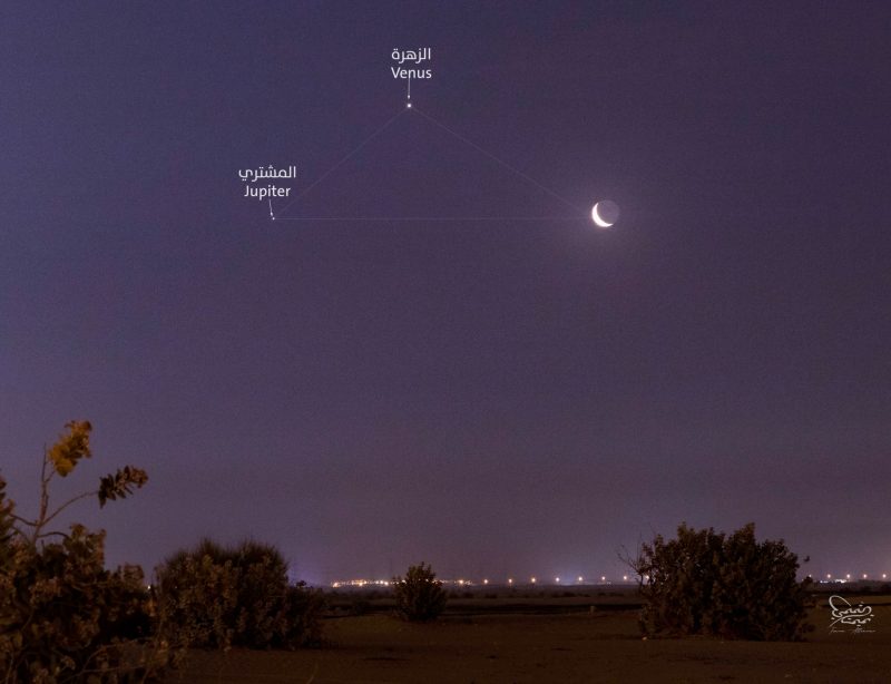 Jupiter, Venus and the moon form a triangle in a purple sky.