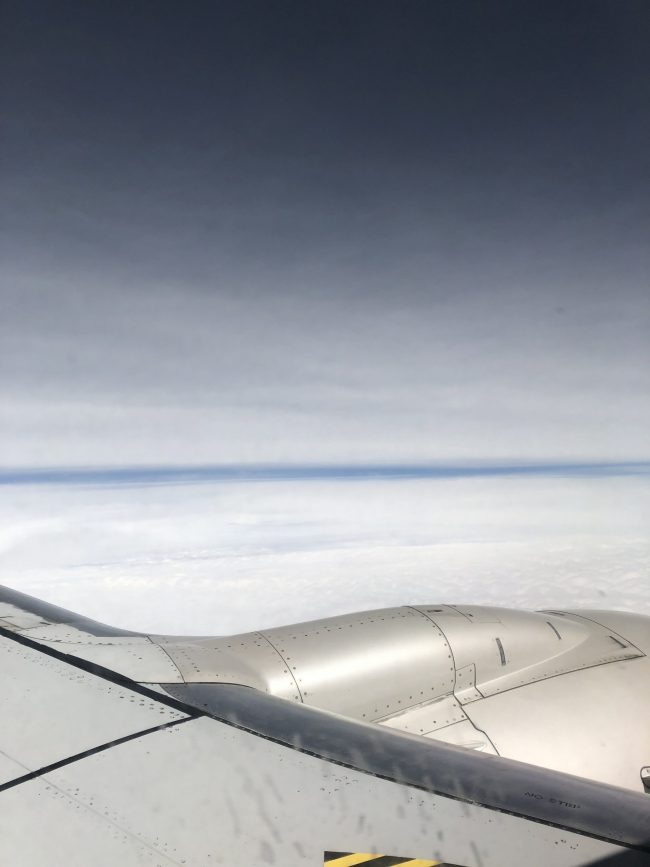 White sail above the plane and white sail below with a thin blue line on the horizon.