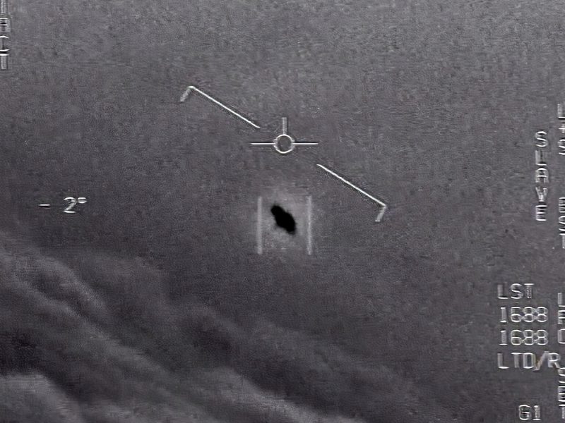 Small oblong black object at angle on gray background, with tick marks showing plane attitude.