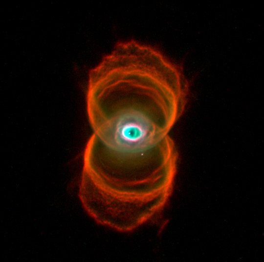 Bright eye-like blue and white spot at center with two overlapping red rings above and below.