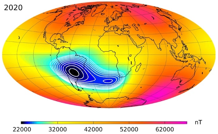 Mapa ovalado de la Tierra con intensidades magnéticas de colores y una mancha oscura sobre y cerca de América del Sur.