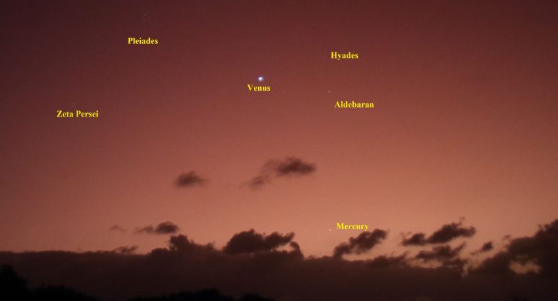 Stars and planets are visible over the clouds. Venus is the brightest and is in the middle.