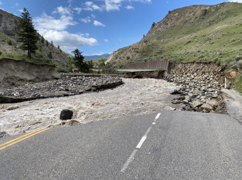 Yellowstone: A demolished road, next to a stream.