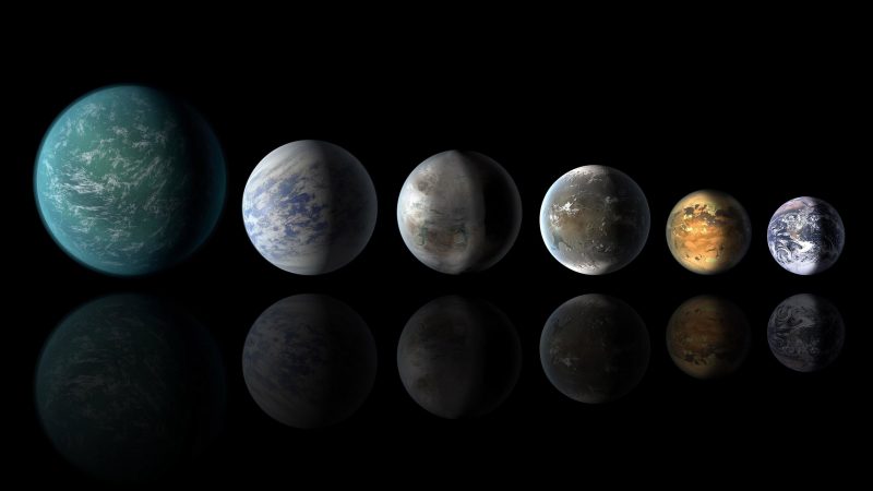 Six planets lined up in size, mostly bluish with clouds, and all different.