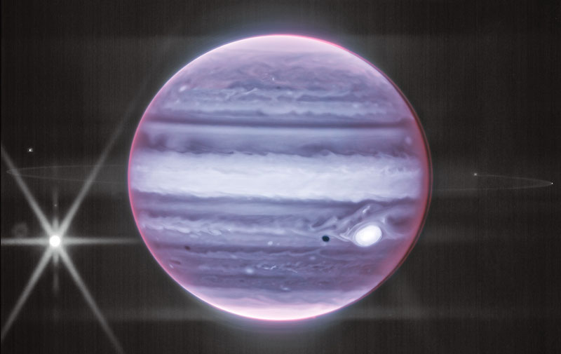 Jupiter's rings: Purple planet with banded atmosphere, bright spot on right side barely visible fuzzy rings.