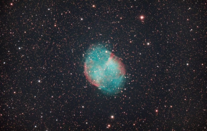 Green spherical cloud in a star field.