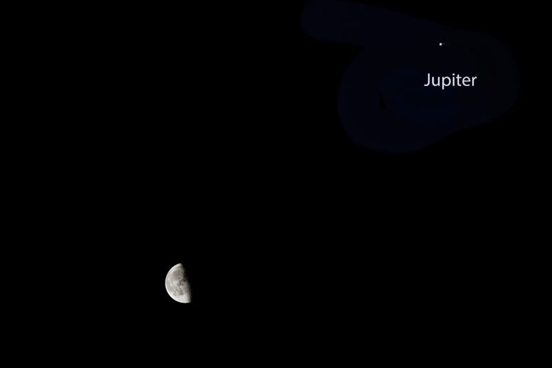 Last quarter moon with Jupiter on a dark starless sky.