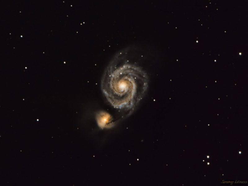 Yellowish spiral with a ball of light at the end of one arm.