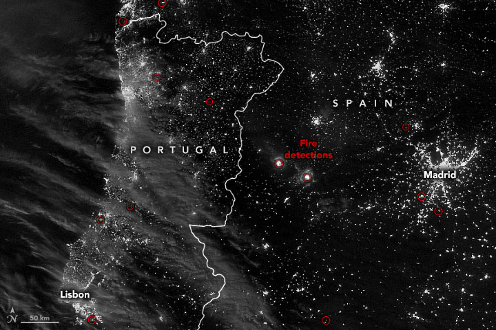 View of the Iberian peninsula, from space at night, with 2 dots labeled fire detections.