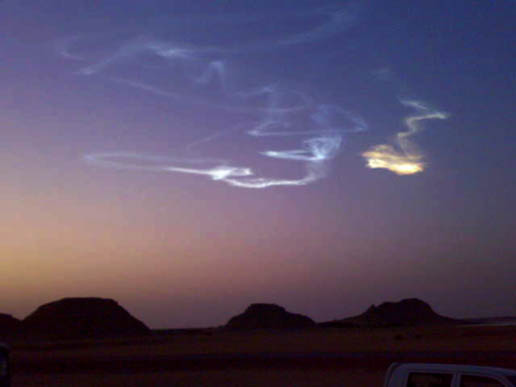 Contrail of meteor descent in twilight sky.
