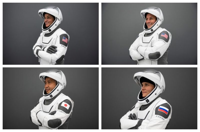 Four people in spacesuits.