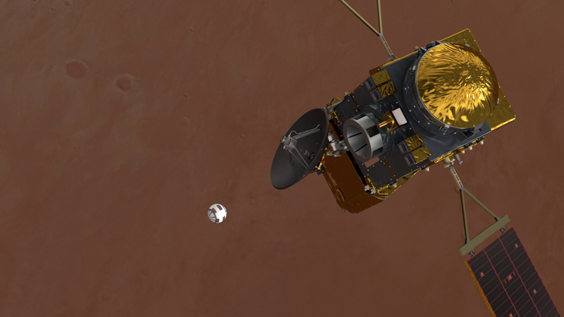 Orbiting spacecraft will smaller ball-like object floating below it.