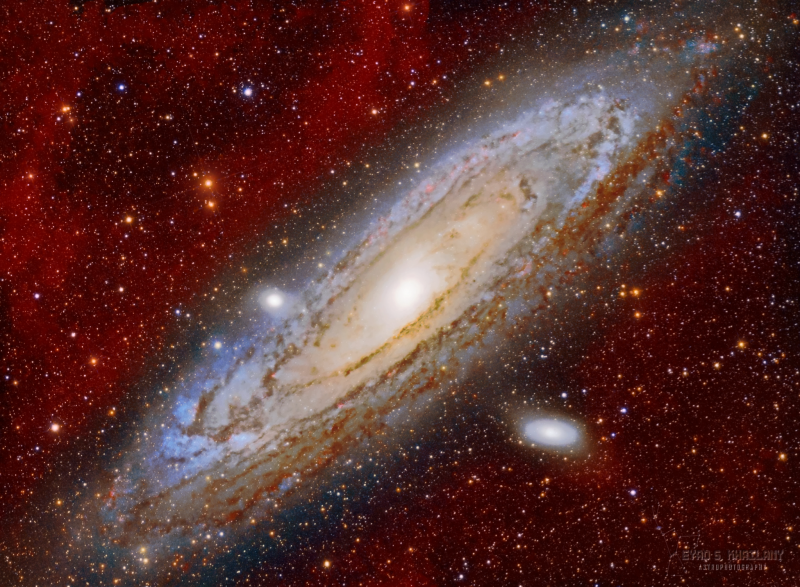 Detailed oblique view of spiral galaxy with foreground stars and reddish background.