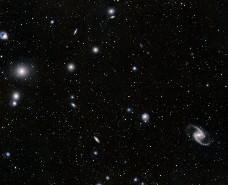 Scattering of a 15 or so small-appearing galaxies in star field.