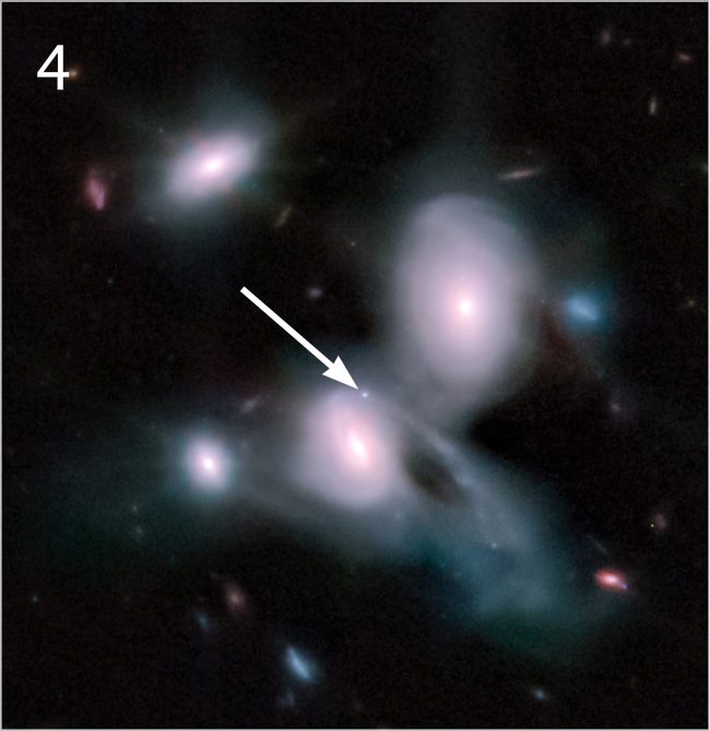 Roundish galaxies close together with bright point of light and arrow indicating its location.