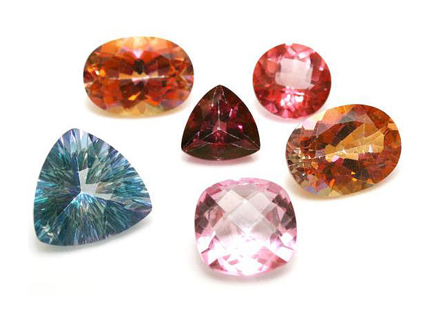 Glittering faceted gemstones in several colors: round, oval, square, and triangular.