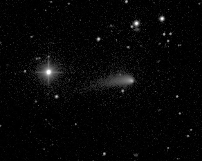 Bright star with spikes next to fuzzy comet with tail pointing left.