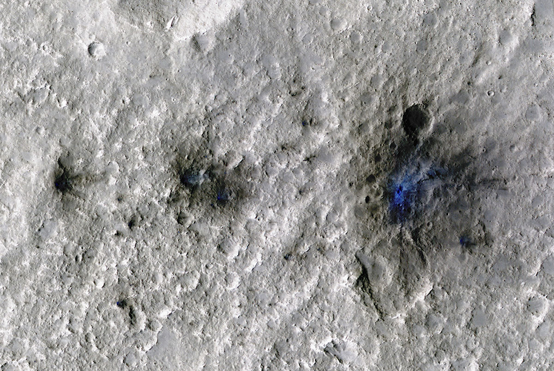 InSight hears meteoroid impacts: 3 irregular black and blue areas on gray cratered terrain.