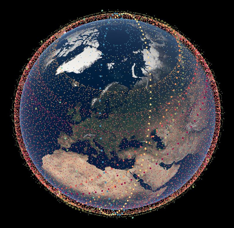 Satellites harm astronomy: Image of Earth with dots circling most of globe, Arctic area somewhat open.