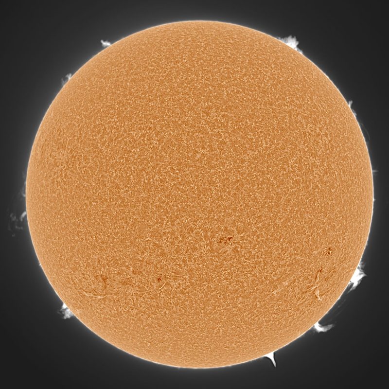 The sun, seen as a large orange sphere with a mottled surface.