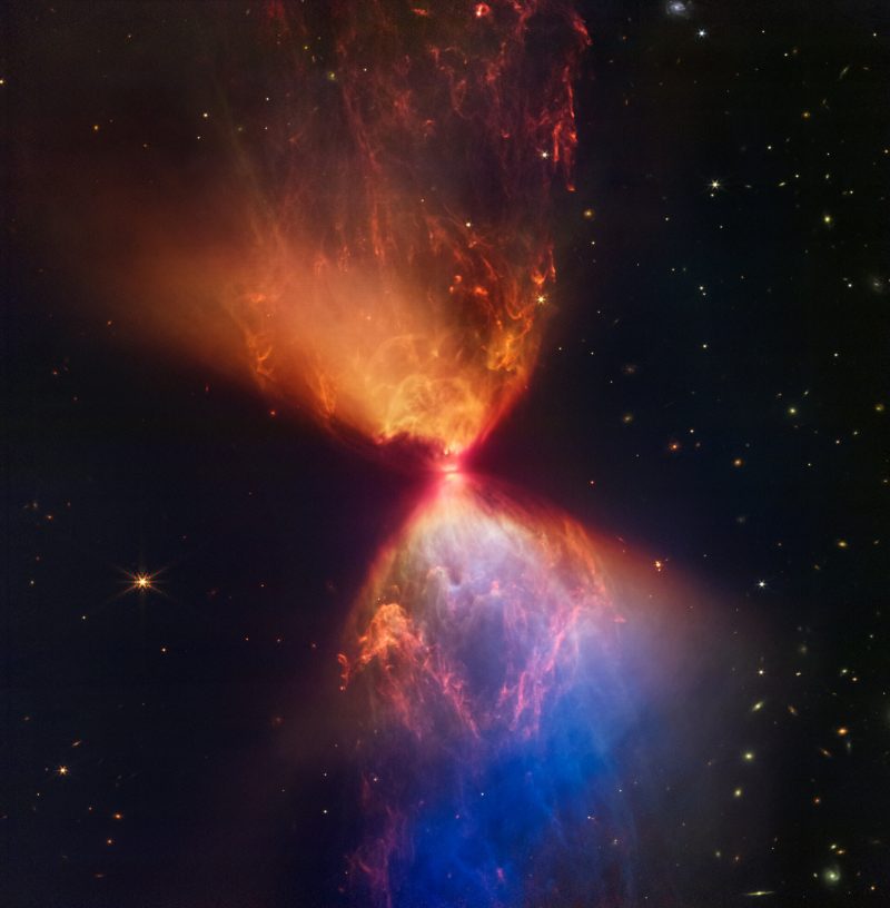 Fiery hourglass star: Brilliant, colorful gases flaring outward symmetrically from a tiny bright area.