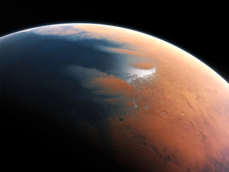 Ancient ocean on Mars: Planet with ocean on the left side and reddish cratered terrain on the right.