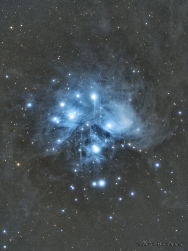 Large area of blue nebulosity with bright stars immersed within.