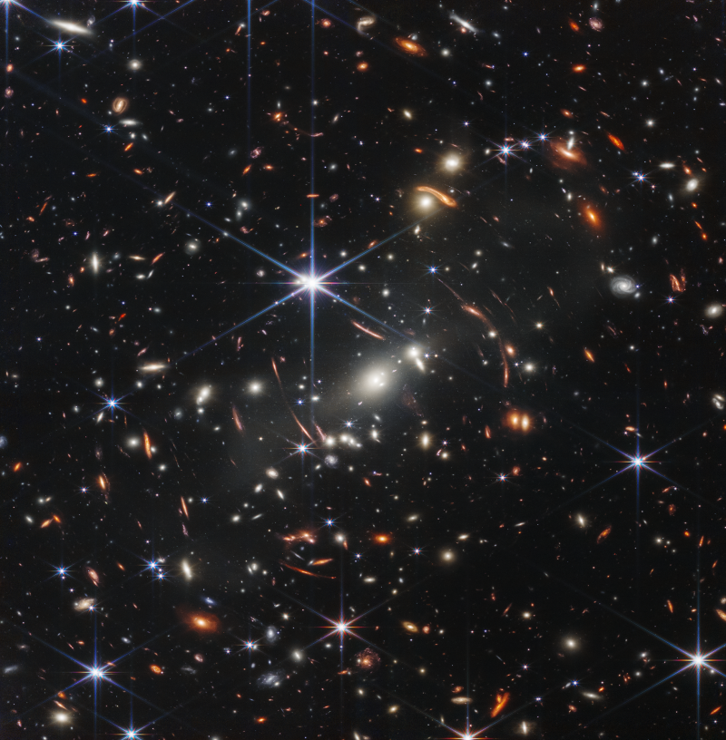 Universe is expanding: Very, very many mostly tiny-appearing galaxies in different colors on a black background.
