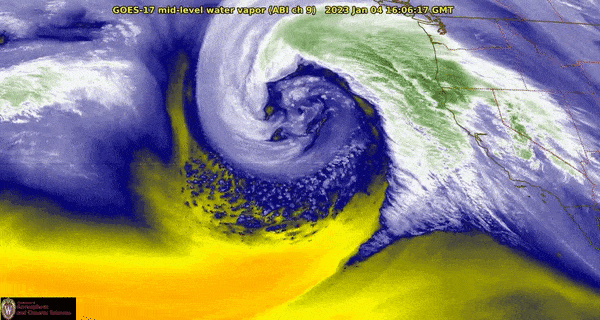 Satellite image of a colorful swirl of bomb cyclone off west coast of North America.