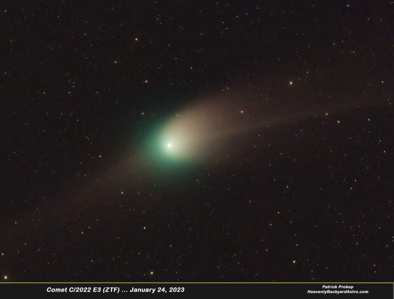 Fuzzy comet with green and white head and darker tail, with shadowy tail in 2nd direction.