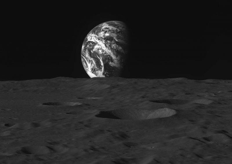 Korean moon probe: Black and white photo of distant view of half-Earth over dark gray lunar surface.
