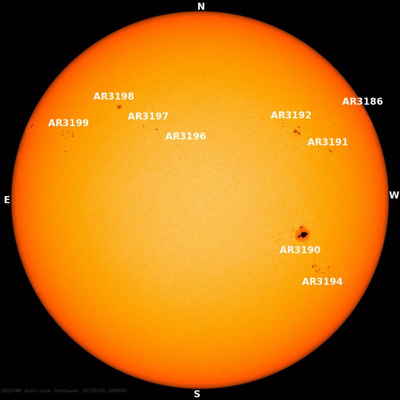 The sun, seen as a yellow sphere with dark spots.