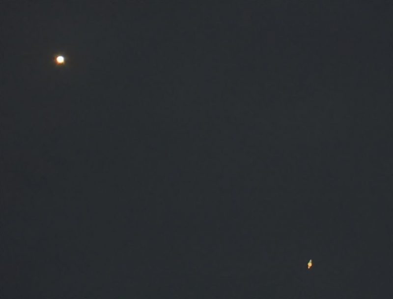 Large bright dot in upper left, smaller one with rings in lower right.