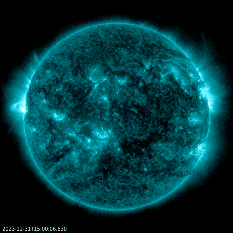 X flares: Mottled blue disk of sun, with brilliant white flare flashing on the left edge.