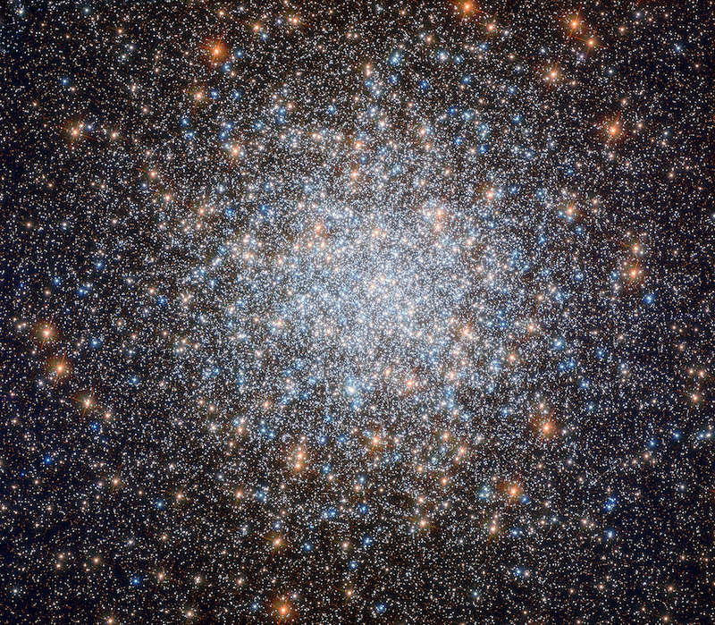 Milky Way's farthest stars: Millions of different colored stars in a large bright round cluster denser toward the middle.