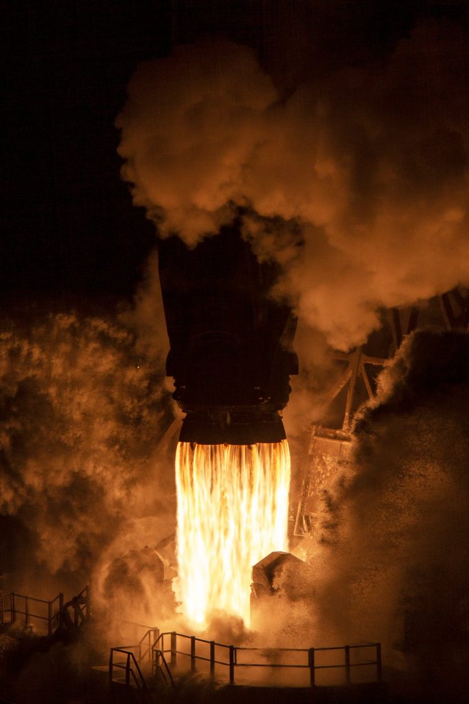 Close up of a SpaceX rocket firing night smoke.